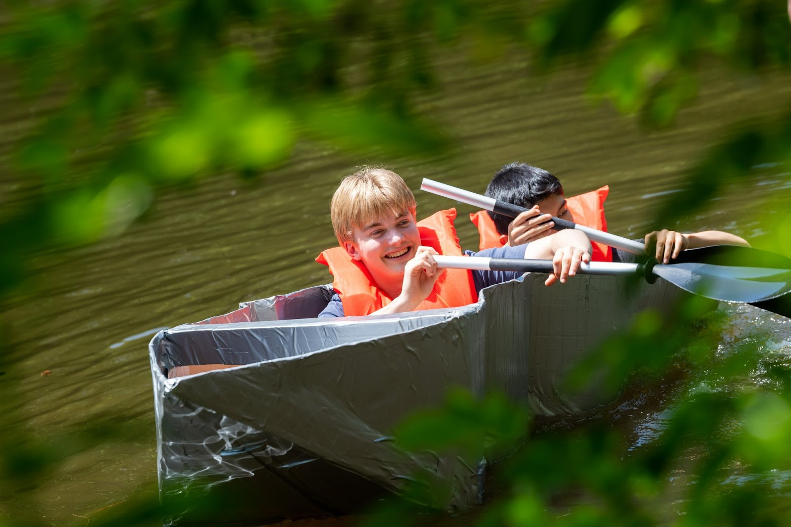 students in cardboard boats